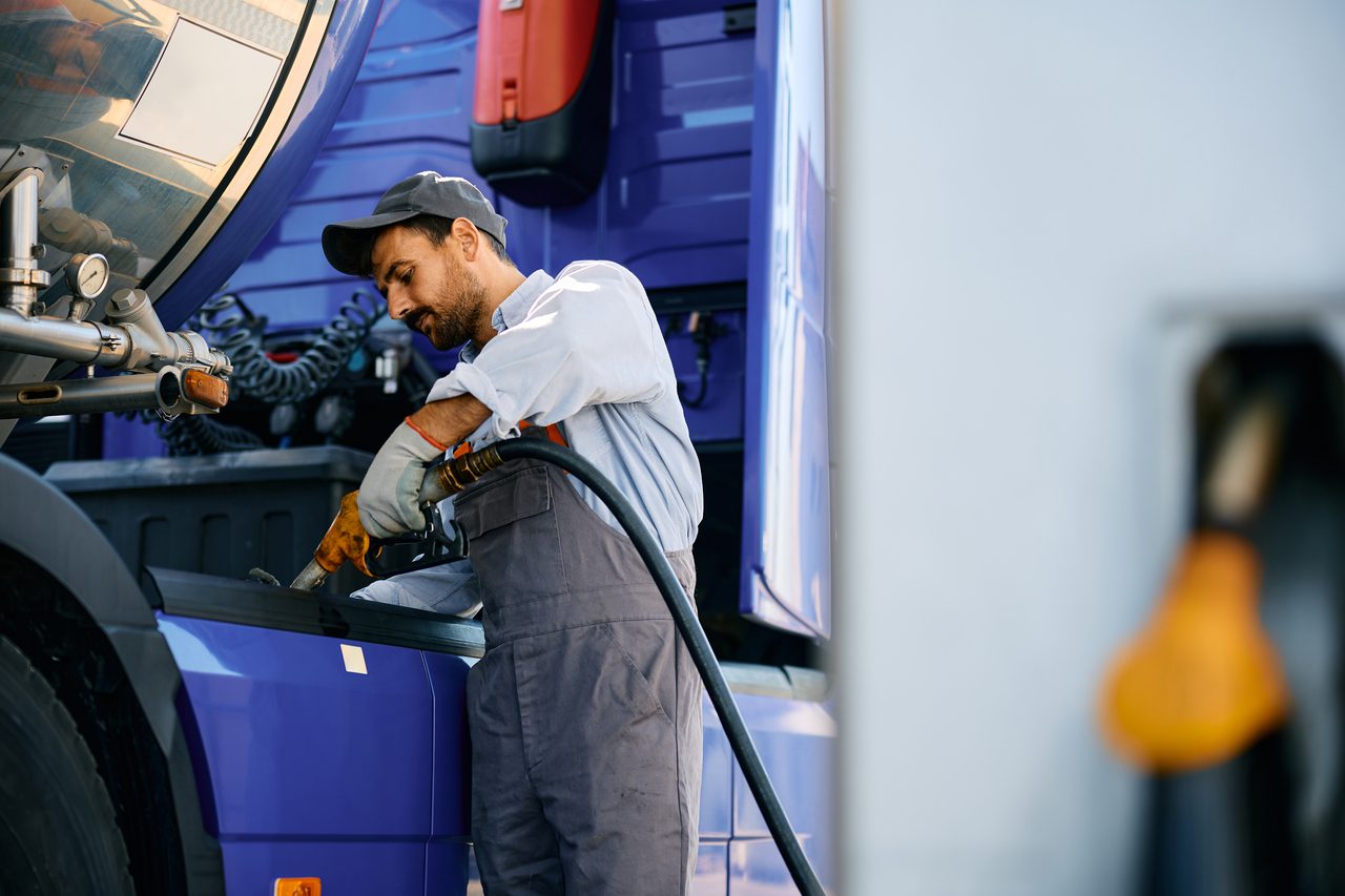 A man working on the side of a truck.