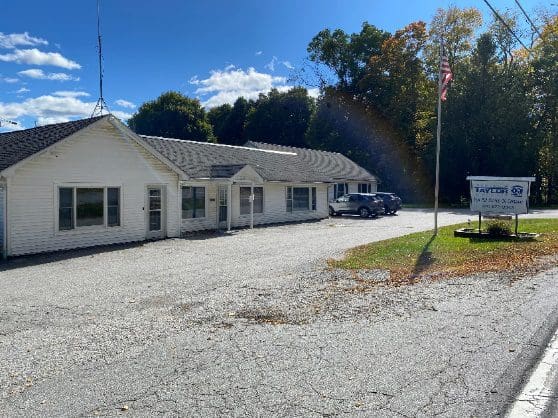 A white building with a rainbow in the background.