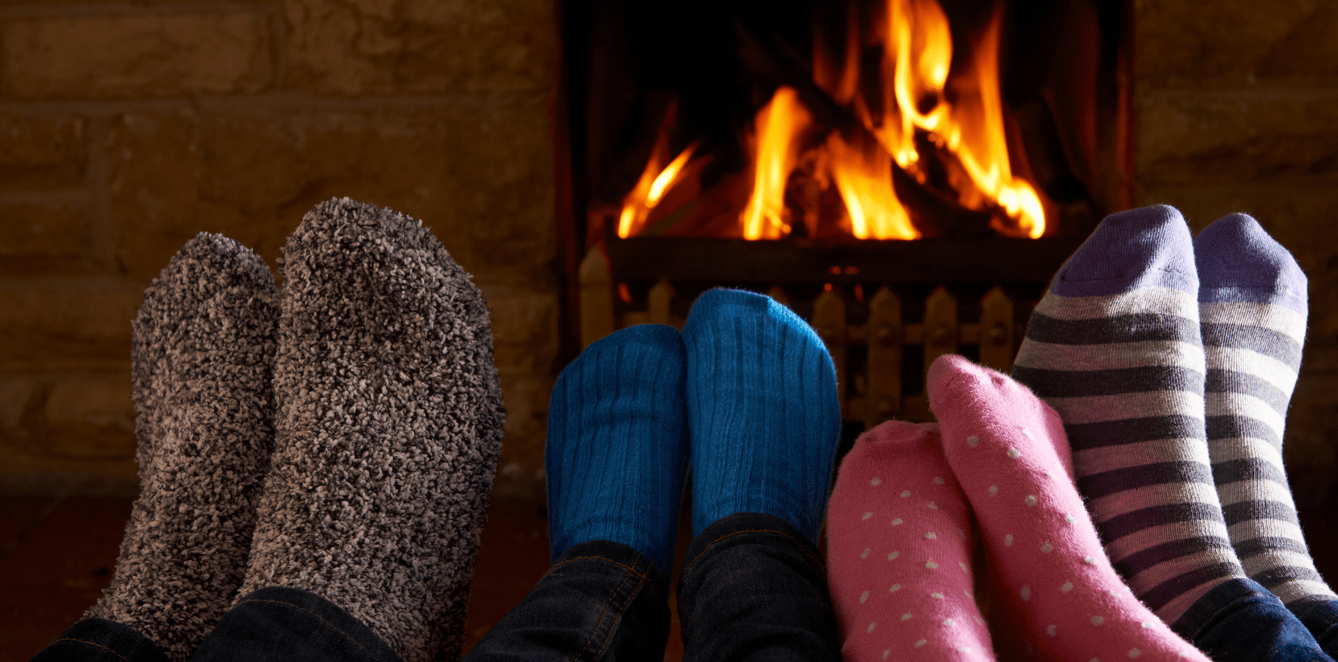 A couple of people that are sitting in front of a fire