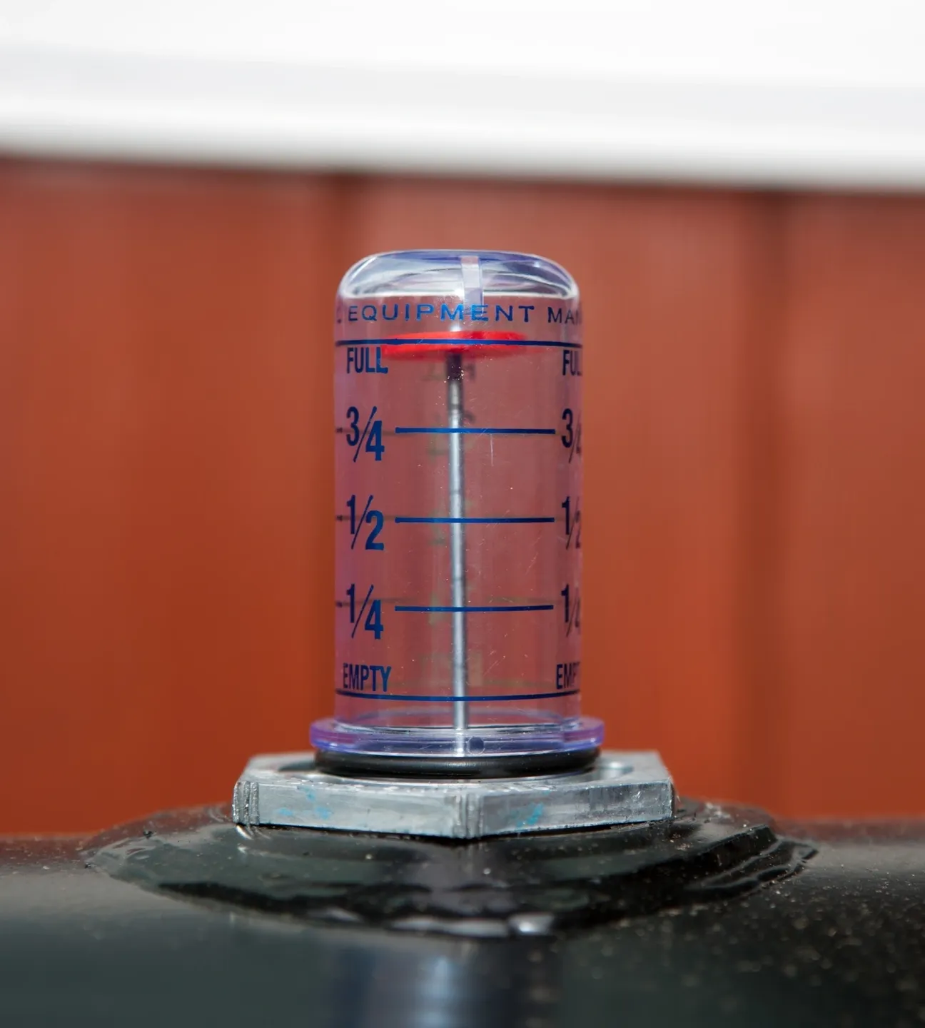 A close up of an air gauge on the side of a building